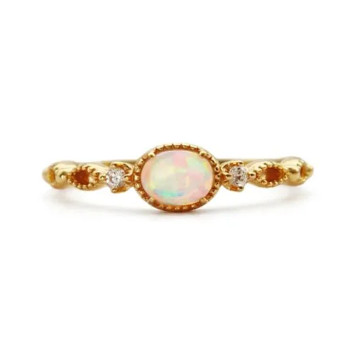 Gold plated sterling silver ring with oval synthetic opal and cubic zirconia accents
