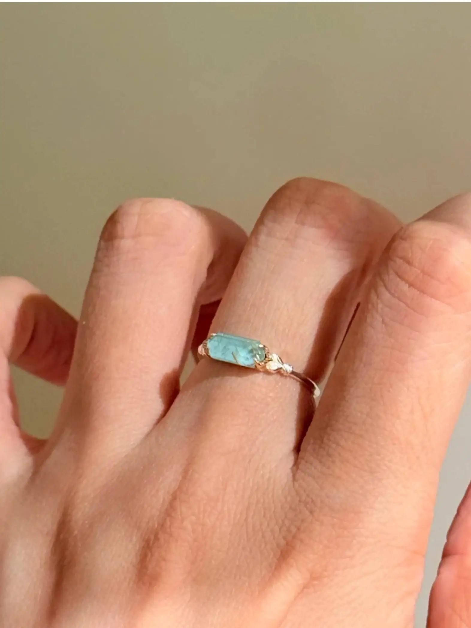 925 sterling silver ring featuring a rectangular bar-cut natural sea green rutilated quartz stone with subtle wire wrapping details