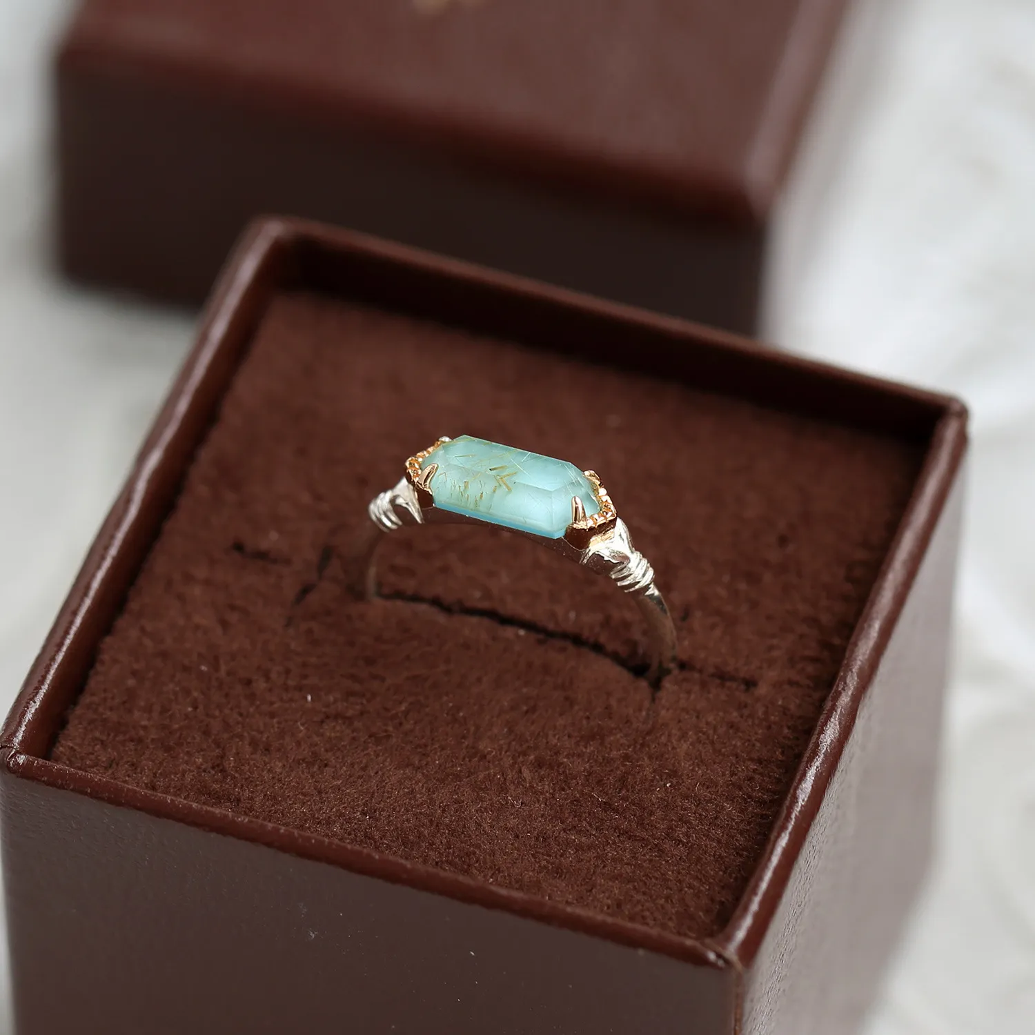 925 sterling silver ring featuring a rectangular bar-cut natural sea green rutilated quartz stone with subtle wire wrapping details