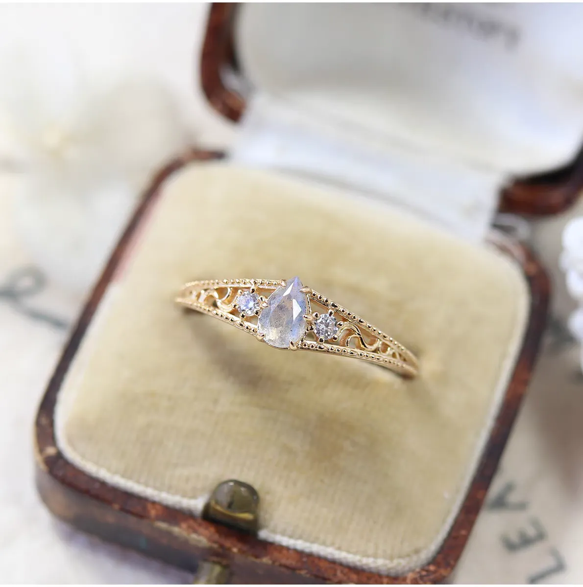 Gold-plated 925 sterling silver vintage ring featuring a pear-cut natural labradorite stone surrounded by floral vine filigree details and cubic zirconia accents