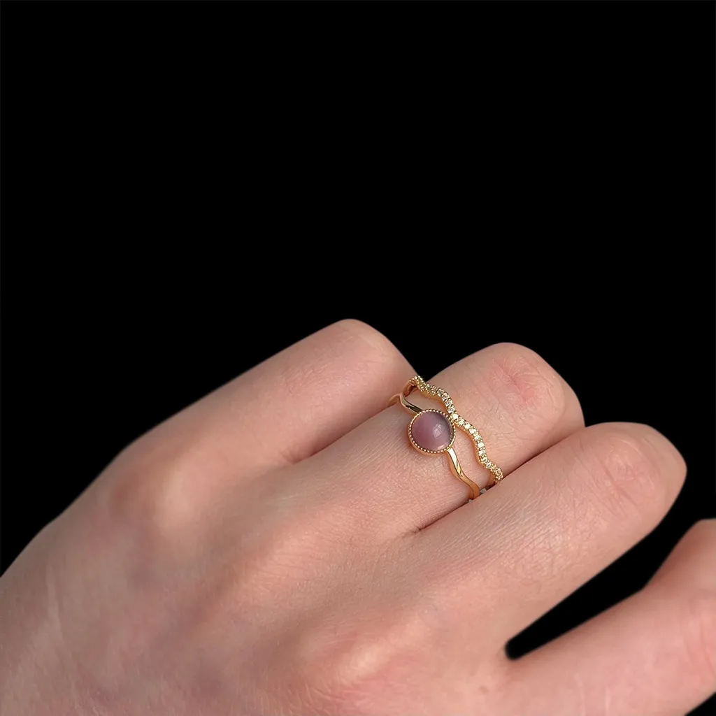 Woman wearing the adjustable double-band cat's eye ring on her finger
